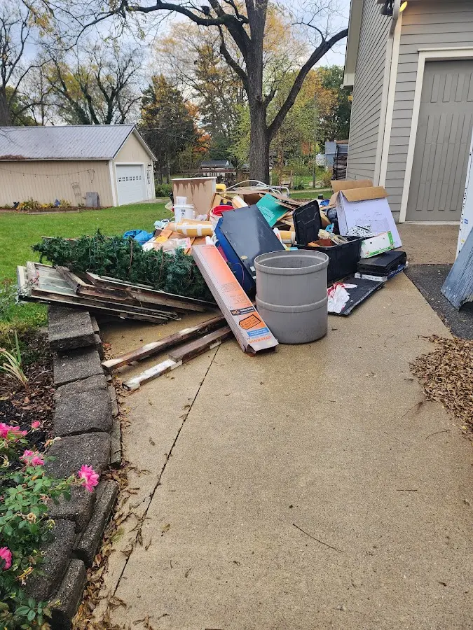 Dumpster being loaded with debris for Estate Cleanout Dumpster Rental in Sparta